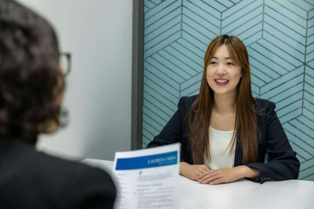 resume-genius-72D3z_LfrQA-unsplash A hiring manager interviewing a candidate.